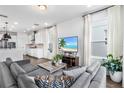Bright living room featuring sleek furniture, hardwood floors, and an open floor plan at 17087 Wynford Ln, Winter Garden, FL 34787