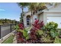 Close up of the front yard with tropical landscaping surrounding the walkway to the front door at 2271 Delhi Pl, Sanford, FL 32771