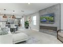 Bright living room featuring a sleek fireplace with television and comfortable modern seating at 2271 Delhi Pl, Sanford, FL 32771