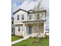 Charming two-story home featuring a welcoming front porch, blue door and neutral siding at 2354 Broadbrook Dr, St Cloud, FL 34771