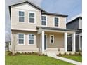 Charming two-story home featuring a welcoming front porch and neutral siding at 2354 Broadbrook Dr, St Cloud, FL 34771