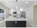 Well-lit kitchen features white cabinets, stainless steel appliances, an island, and views of the outdoors at 2418 Whitehall Cir, Winter Park, FL 32792