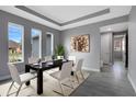 Modern dining room with large windows, stylish decor, and an elegant tray ceiling at 30369 Apricot Ave, Eustis, FL 32736