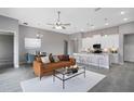 Bright, open-concept living room featuring a kitchen island and stainless steel appliances at 30369 Apricot Ave, Eustis, FL 32736