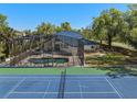 The backyard features a screened pool, spa, and tennis court at 3326 Butler Bay N Dr, Windermere, FL 34786