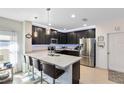 Sleek kitchen featuring an island with seating, stainless steel appliances, and ample counter space at 34626 Salerno Cir, Sorrento, FL 32776