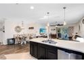Bright, open kitchen with an island, seamlessly connecting to the dining and living areas at 34626 Salerno Cir, Sorrento, FL 32776