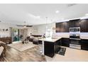 Open concept living room and kitchen with modern appliances and plenty of natural light at 34626 Salerno Cir, Sorrento, FL 32776
