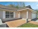 Inviting front porch with brick paving, offering a welcoming entrance to the home at 36 Se Almond Dr, Ocala, FL 34472