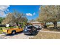 Inviting single-story home with a long driveway and an attached two-car garage, surrounded by mature trees at 37149 Sandy Ln, Grand Island, FL 32735