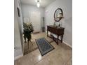 Bright entryway featuring tile flooring, a decorative rug, and a charming accent table at 3823 Ryegrass St, Clermont, FL 34714