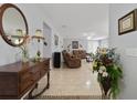Inviting living room featuring tile floors, comfortable brown sofas, and tasteful decor at 3823 Ryegrass St, Clermont, FL 34714