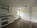 This kitchen boasts new appliances, wood-look flooring, and a bright, spacious area with natural light at 3931 Avenue R Nw, Winter Haven, FL 33881