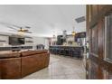 Inviting living room with an open layout, tile floors, a ceiling fan, and barstool seating at the kitchen island at 415 Flagler Rd, Winter Haven, FL 33884