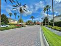Grand entrance to the community with paved brick road and lush landscaping at 604 Fortanini Cir, Ocoee, FL 34761