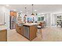 Open-concept kitchen with stainless steel appliances and large island flows into the living area at 8718 Sw 139Th Place Rd # 29, Ocala, FL 34473