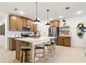 Modern kitchen featuring a large island, stainless steel appliances, and stylish pendant lighting at 8718 Sw 139Th Place Rd # 29, Ocala, FL 34473