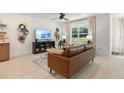 Cozy living room with a comfortable leather sofa, media center, and bright natural light at 8718 Sw 139Th Place Rd # 29, Ocala, FL 34473