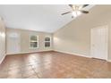 Open living room with neutral paint, high ceilings and tile floors at 9526 Water Fern Cir, Clermont, FL 34711