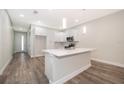 Modern kitchen featuring an island with seating, stainless appliances, and ample storage space at 1104 Grove Manor Dr, Sanford, FL 32771