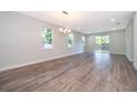 Spacious open-concept living area with hardwood flooring, natural light, and sliding glass door to backyard at 1104 Grove Manor Dr, Sanford, FL 32771