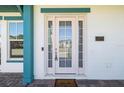 Inviting home entrance with sidelights, stylish address plate, and welcome mat at 13676 Mcmillan Dr, Orlando, FL 32827