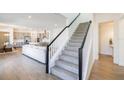 Open-concept living space with a staircase, wood-look flooring, and modern design at 13676 Mcmillan Dr, Orlando, FL 32827