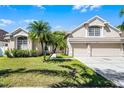 Charming single-Gathering home featuring lush landscaping, a two-car garage, and a well-manicured front lawn at 14136 Magnolia Glen Cir, Orlando, FL 32828
