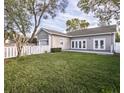 Expansive backyard featuring a lush lawn, privacy fence, and easy access to the house at 1513 Pinecrest Pl, Orlando, FL 32803