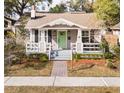 Inviting bungalow with a gabled roof, covered front porch, and well-maintained landscaping at 1513 Pinecrest Pl, Orlando, FL 32803