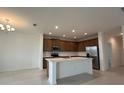 Spacious kitchen with stainless steel appliances, white countertops, and a central island at 1996 Heart Lake Dr, Groveland, FL 34736