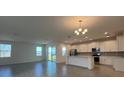 Open-concept living room and kitchen area with tiled flooring and abundant natural light at 2000 Heart Lake Dr, Groveland, FL 34736