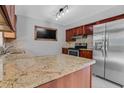 Modern kitchen features granite countertops, stainless steel appliances, and wood cabinets at 2102 Nedra Ave, Deltona, FL 32725