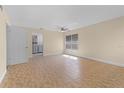 Open-concept living room featuring tile flooring, ceiling fan, and natural light at 2605 S Elm Ave, Sanford, FL 32773