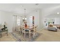 Cozy dining room features a wooden table with seating for six, an area rug, and an open layout at 2679 Metro Sevilla Dr # 101, Orlando, FL 32835