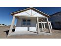 Inviting front porch showcasing a new home's architectural details and windows at 30125 Misty Pines Rd, Mount Dora, FL 32757