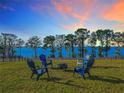 Stunning backyard space with Adirondack chairs and fire pit, ideal for outdoor entertaining at 3279 Landing Vw, Tavares, FL 32778