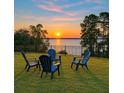 Beautiful backyard seating area overlooking the lake, perfect for relaxing and enjoying scenic views at 3279 Landing Vw, Tavares, FL 32778