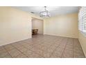 Spacious living room with neutral paint, tile flooring, and modern lighting fixture at 333 Crystal Cir, Oviedo, FL 32765