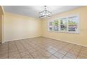 Well-lit living room with tile flooring, large windows, and plantation shutters at 333 Crystal Cir, Oviedo, FL 32765