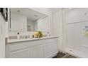 Bright bathroom featuring double vanity, modern fixtures, and walk-in shower at 3739 Bluethread Way, Poinciana, FL 34759