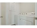 A bright laundry room with a modern washer and dryer provides convenience at 3739 Bluethread Way, Poinciana, FL 34759