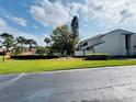 Well-maintained community with lush green spaces, mature trees, and a glimpse of the pool area at 4100 Player Cir # 101, Orlando, FL 32808