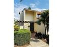 Charming two-story home with modern architecture, a cozy pergola entryway, and mature landscaping at 4100 Player Cir # 101, Orlando, FL 32808