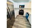Modern kitchen featuring stainless steel appliances, white cabinets, and sleek countertops at 4100 Player Cir # 101, Orlando, FL 32808