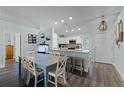Open kitchen and dining area with granite countertops, a breakfast bar, and modern appliances at 4321 Iveyglen Ave, Orlando, FL 32826