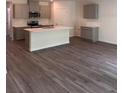 Spacious kitchen with a large center island, stainless steel appliances, and wood flooring at 511 Coronado Cove Rd, New Smyrna Beach, FL 32168