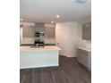 Modern kitchen featuring stainless steel appliances, a large island, and stylish cabinetry at 511 Coronado Cove Rd, New Smyrna Beach, FL 32168