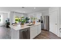 Modern kitchen with stainless steel appliances, a center island with a sink, and sleek cabinetry at 514 Coronado Cove Rd, New Smyrna Beach, FL 32168