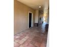 Hallway with tiled floor and door leading into unit at 5578 Metrowest Blvd # 305, Orlando, FL 32811